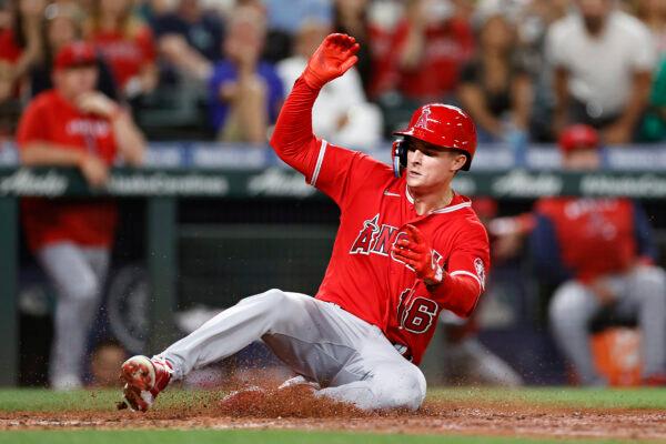 Mickey Moniak (16) of the Los Angeles Angels scores a run during the ninth inning against the Seattle Mariners at T-Mobile Park in Seattle, on Aug.  6, 2022. (Steph Chambers/Getty Images)