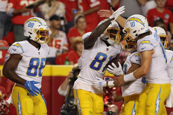 Mike Williams (81) of the Los Angeles Chargers celebrates with Justin Herbert (10) after scoring a touchdown during the third quarter against the Kansas City Chiefs at Arrowhead Stadium in Kansas City, on Sept. 15, 2022. (Jamie Squire/Getty Images)