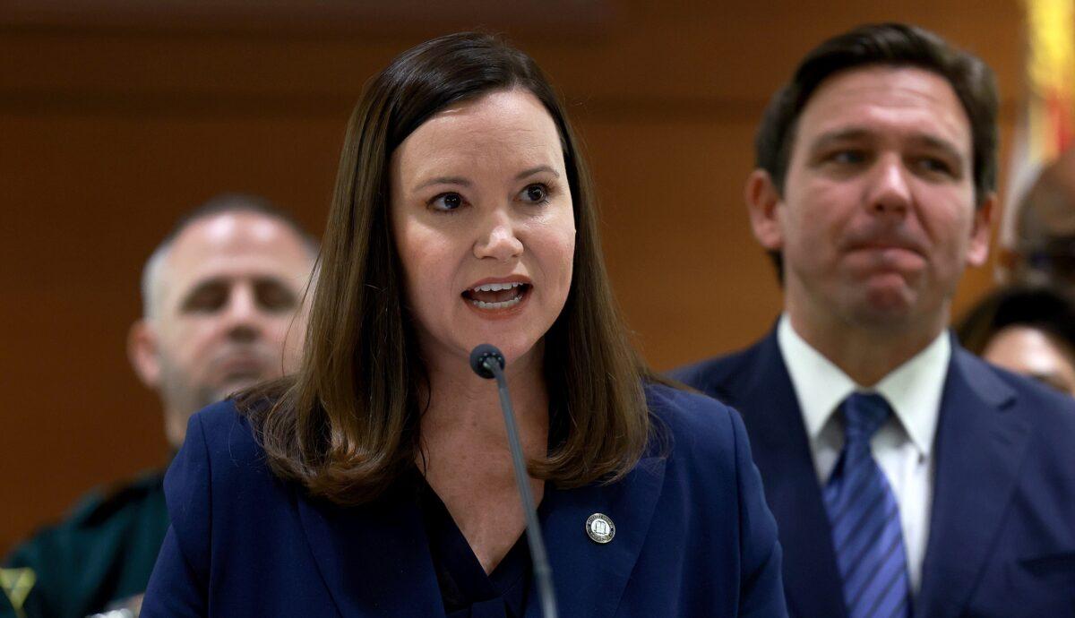 Florida Gov. Ron DeSantis listens as Florida Attorney General Ashley Moody speaks during a press conference at the Broward County Courthouse in Fort Lauderdale, Fla., on Aug. 18, 2022. (Joe Raedle/Getty Images)