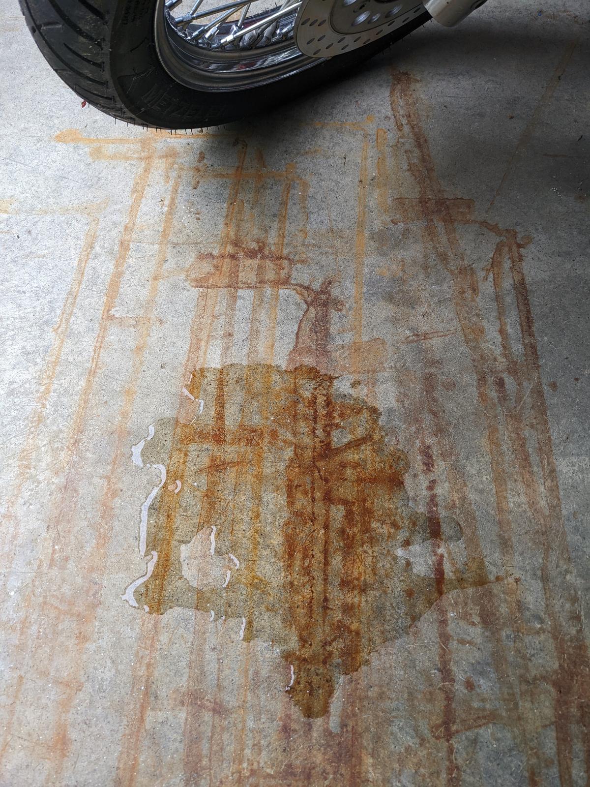 BEFORE: These are rust stains on a garage floor left by a snowblower. The puddle in the middle is an oxalic acid solution. (Tim Carter/TNS)