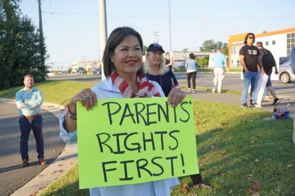 Fairfax County resident Lin-Dai Kendall protests at a rally outside Luther Jackson Middle School before a Fairfax County Public Schools board meeting, in Falls Church, Va., on Sept. 15, 2022. (Terri Wu/The Epoch Times)