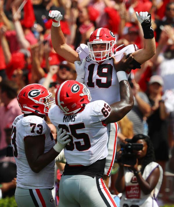 Georgia tight end Brock Bowers gets a hoist in the endzone by offensive lineman Amarius Mims after scoring his second touchdown of the first half of an NCAA college football game against South Carolina in Columbia, S.C., on Sept. 17, 2022. (Curtis Compton/Atlanta Journal—Constitution via AP Photo)
