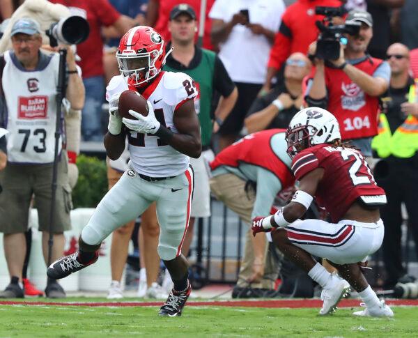 Georgia defensive back Malaki Starks intercepts a pass intended for South Carolina running back Juju McDowell during the first half of an NCAA college football game in Columbia, S.C., on Sept. 17, 2022. (Curtis Compton/Atlanta Journal—Constitution via AP Photo)
