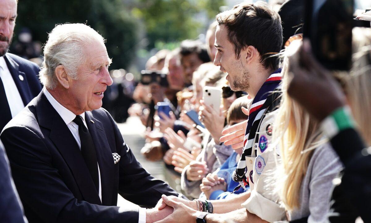 King Charles III meets members of the public as they wait to view Queen Elizabeth II lying in state ahead of her funeral, in the queue along the South Bank, near to Lambeth Bridge, London, on Sept. 17, 2022. (Aaron Chown/PA Media)