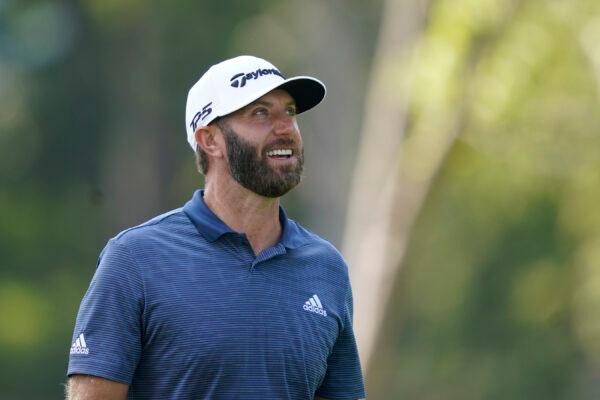 Dustin Johnson looks at the trees he hit his tee shot over on the 12 hole during the first round off the LIV Golf Invitational-Chicago tournament in Sugar Grove, Ill., on Sept. 16, 2022. (Charles Rex Arbogast/AP Photo)