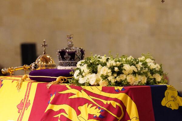 The coffin of Queen Elizabeth II, draped in the Royal Standard with the Imperial State Crown and the Sovereign's orb and sceptre, lying in state on the catafalque in Westminster Hall, at the Palace of Westminster, London, on Sept. 17, 2022. (James Manning/PA Media)
