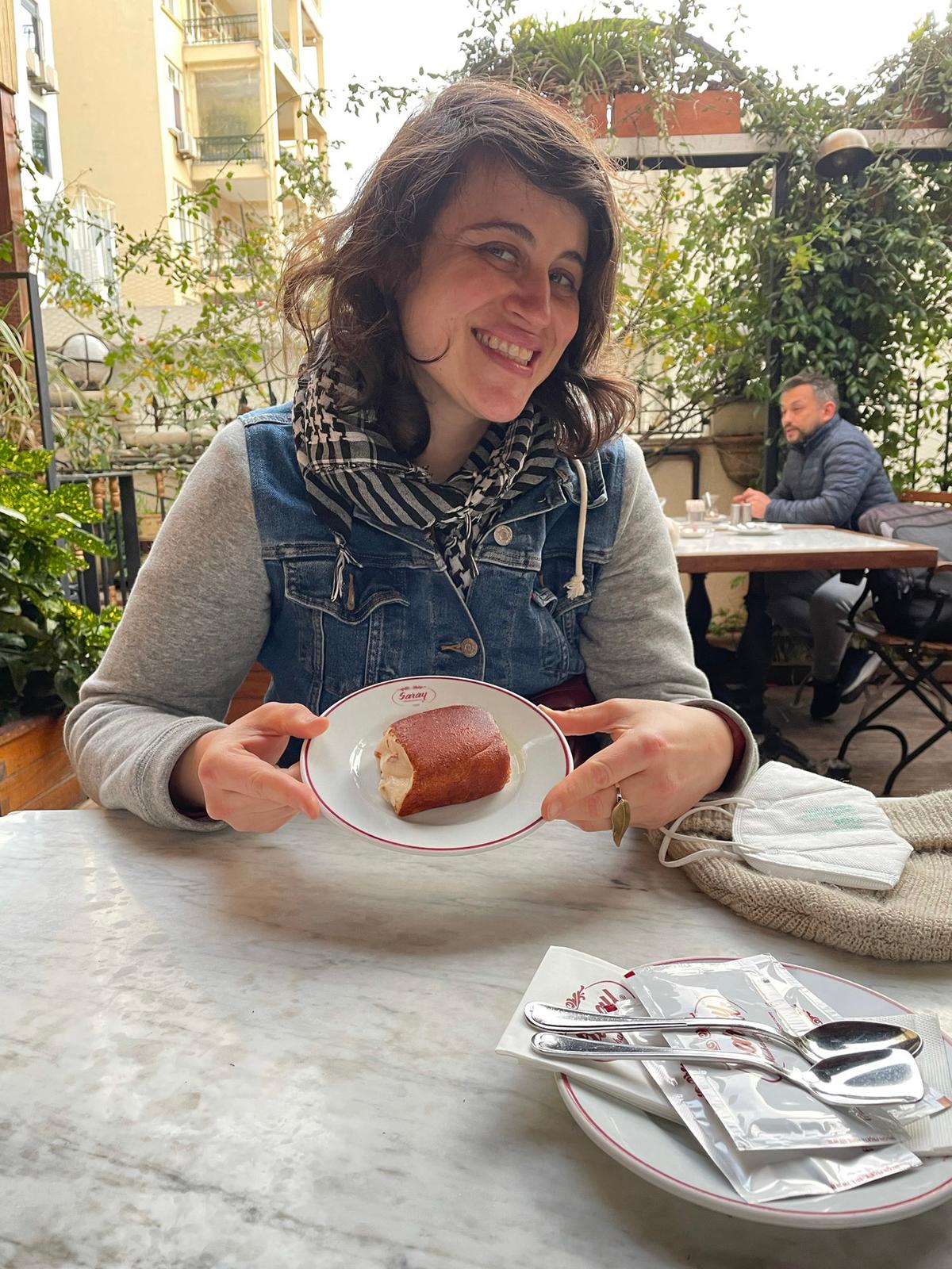 Star Tribune art critic Alicia Eler enjoys a slice of kazandibi, or Turkish burned milk pudding, in a café in Istanbul, Turkey. (Courtesy of Elif Kaya/TNS)