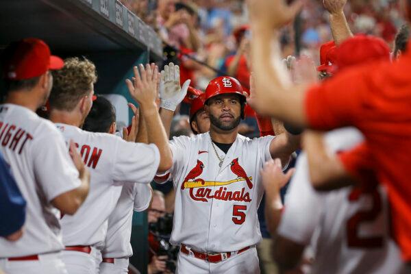 St. Louis Cardinals' Albert Pujols (5) is is congratulated after hitting a two-run home run during the sixth inning of the team's baseball game against the Cincinnati Reds in St. Louis, on Sept. 16, 2022. (Scott Kane/AP Photo)