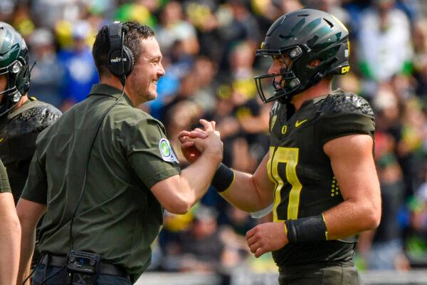 Oregon head coach Dan Lanning greets Oregon quarterback Bo Nix (10) after a touchdown against BYU during the first half of an NCAA college football game in Eugene, Ore., Sept. 17, 2022. (Andy Nelson/AP Photo)