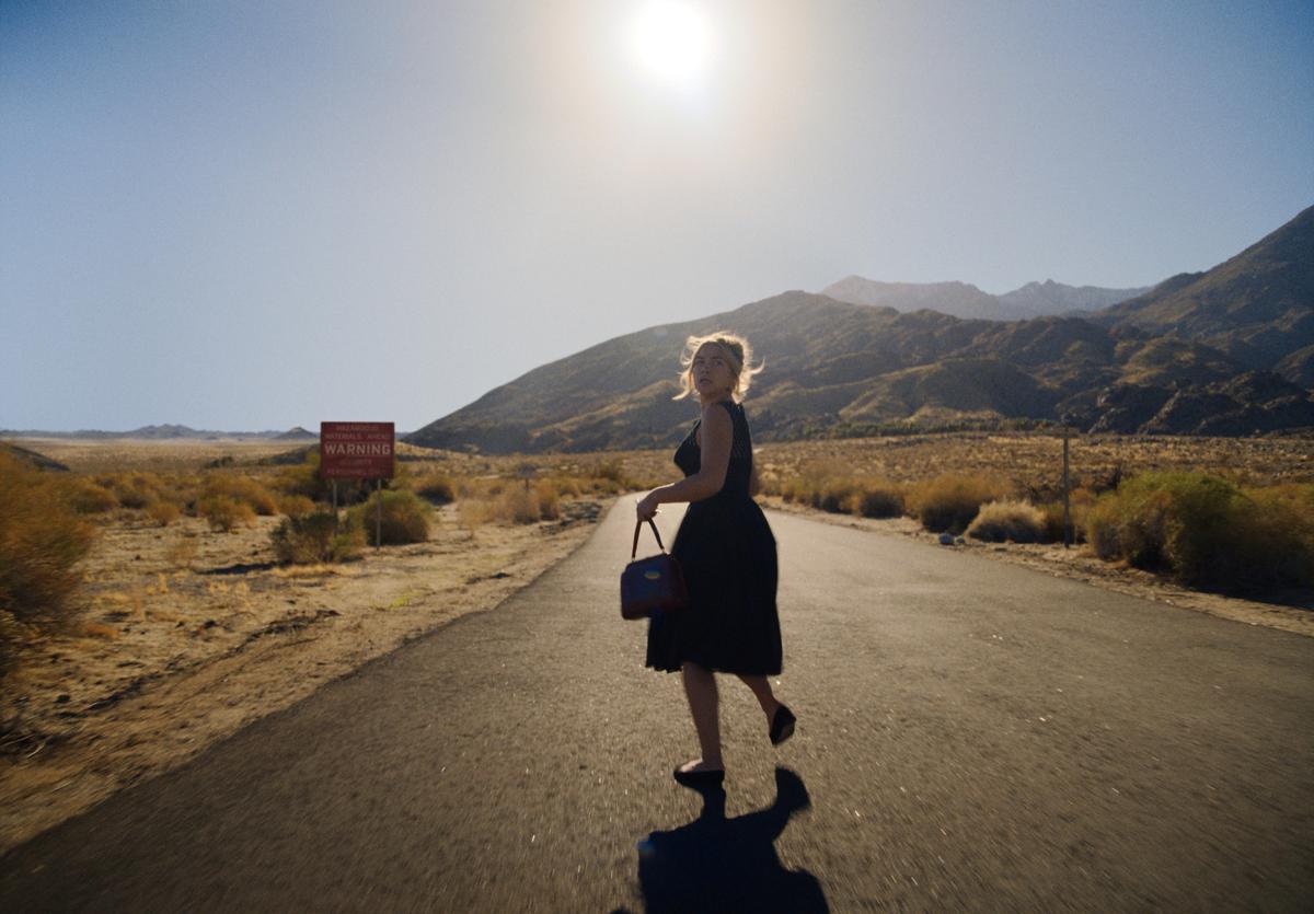 Alice (Florence Pugh) leaves the town limits and heads into the desert to find the plane she saw crash, in "Don't Worry Darling." (Warner Bros. Pictures)