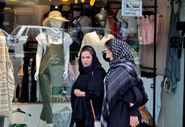 Women wearing headscarves walk near Tajrish Square in Iran’s capital, Tehran, on July 12, 2022. (Atta Kenare/AFP via Getty Images)