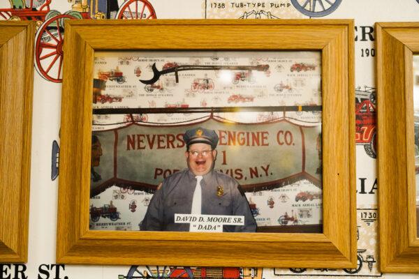 A picture of the patriarch of the four-generation firefighter family, David D. Moore Sr., hangs on the wall of Neversink Engine Company in Port Jervis, N.Y., on September 9, 2022. (Cara Ding/The Epoch Times)