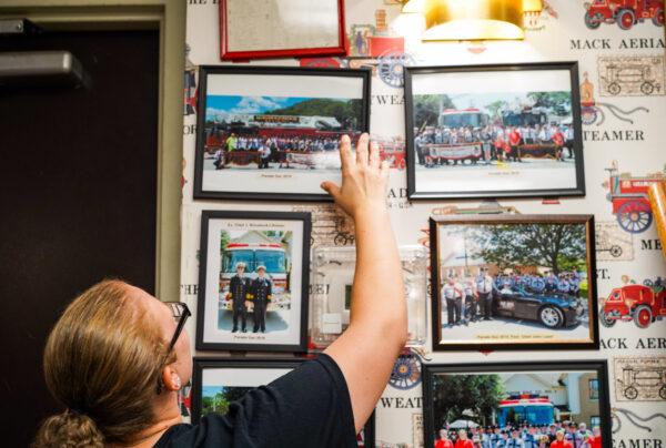 Briana Moore talks about her favorite picture that was taken of her and other volunteer firefighters during the Port Jervis Firemen's Parade in 2015. Shortly after the parade, she would become a junior firefighter. (Cara Ding/The Epoch Times)