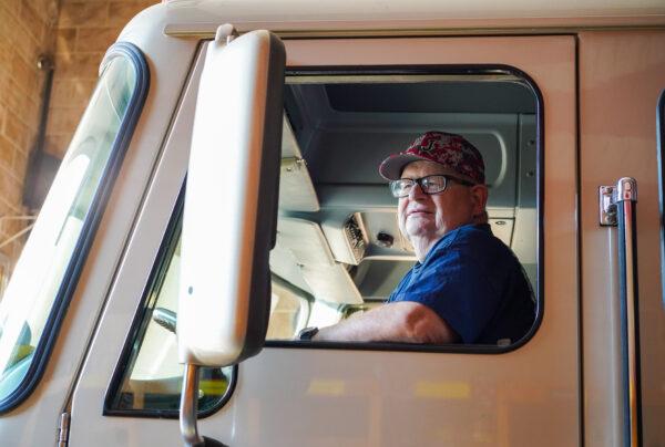 David Moore Sr. sits in the fire engine at Neversink Engine Company in Port Jervis, N.Y., on Sept. 9, 2022. (Cara Ding/The Epoch Times)