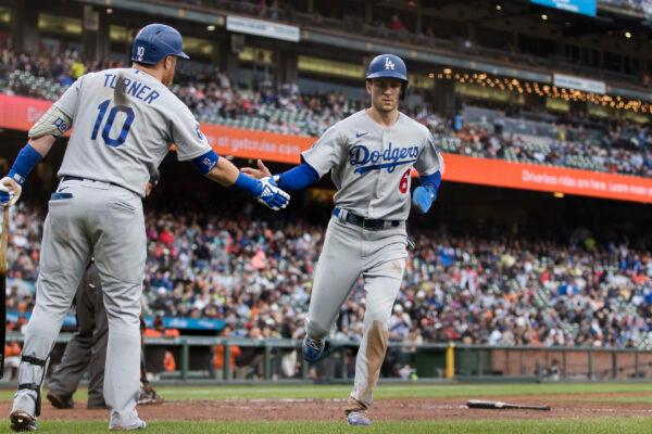 Los Angeles Dodgers' Trea Turner (6) is congratulated by Justin Turner (10) after he scored against the San Francisco Giants during the sixth inning of a baseball game iin San Francisco, on Sept. 18, 2022. (John Hefti/AP Photo)