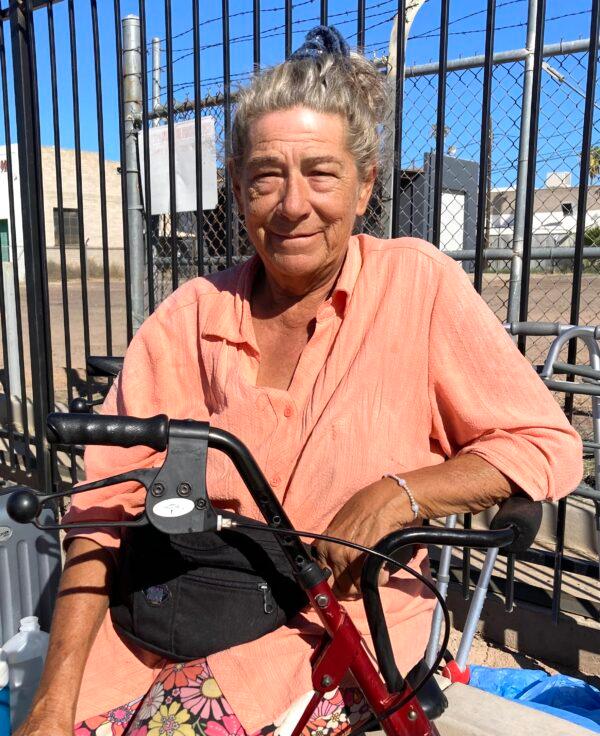 Pam Bejarano, 70, has been living in "The Zone," a growing homeless encampment in Phoenix, for months. She's had just about everything stolen from her, including her heart medication. Here, she sits in the blistering sun on Sept. 18 on a medical scooter. (Allan Stein/The Epoch Times)