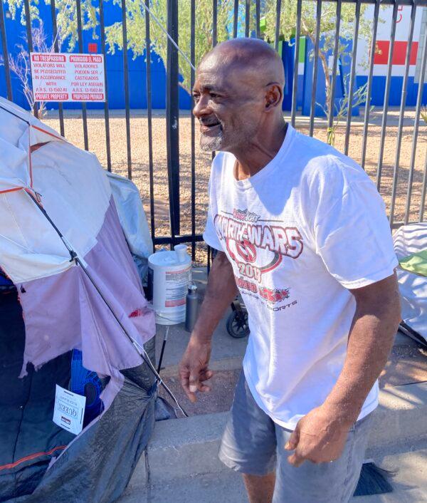 Clarence Carter, 65, walks around his tent keeping it clean on Sept. 18. Carter has been living in The Zone, a homeless encampment in Phoenix, since November after his wife died. (Allan Stein/The Epoch Times)