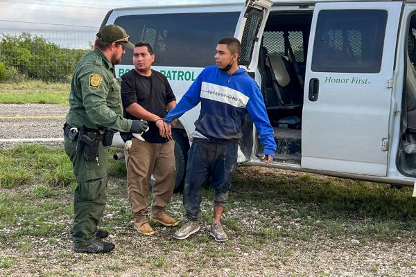 Border Patrol takes into custody six illegal immigrants who were being smuggled from the U.S.–Mexico border, through Kinney County, Texas, on Aug. 28, 2022. One (R) was later discovered to be a wanted child sex offender. (Charlotte Cuthbertson/The Epoch Times)