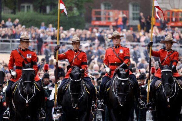 Canadian mounted officers during the procession for the state funeral of Queen Elizabeth II, held at Westminster Abbey, London, on Sept. 19, 2022. (Marko Djurica/PA Media)