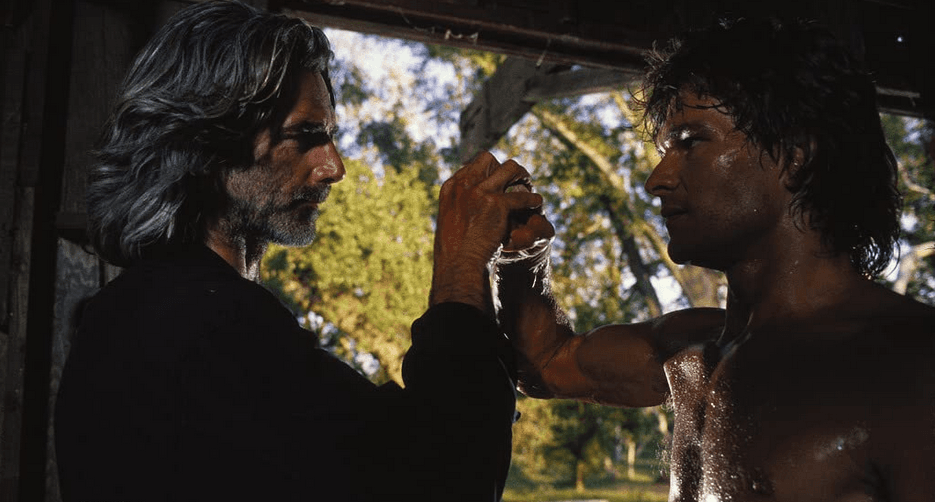 Dalton (Patrick Swayze) goes to punch his mentor Wade Garrett (Sam Elliott), who does a cool Bruce Lee-type, catch-the-fist-like-it's-a-baseball block, in "Road House." (United Artists)