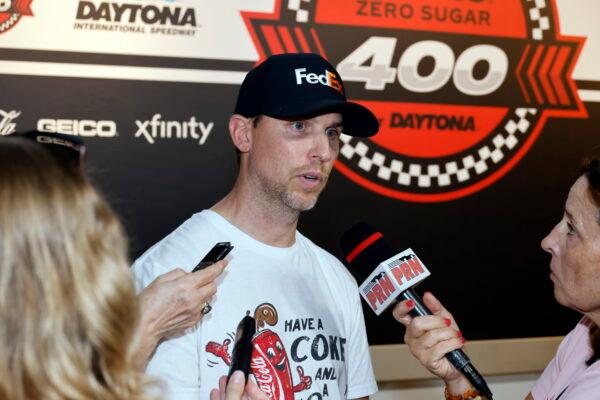 Denny Hamlin answers questions from reporters during a media availability before a NASCAR Cup Series auto race at Daytona International Speedway in Daytona Beach, Fla., on Aug. 26, 2022. (Terry Renna/AP Photo)