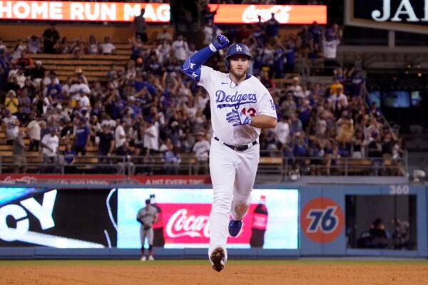 Los Angeles Dodgers' Max Muncy gestures as he heads to third after hitting a two-run home run during the third inning of a baseball game against the San Francisco Giants in Los Angeles, Sept. 6, 2022. (Mark J. Terrill/AP Photo)