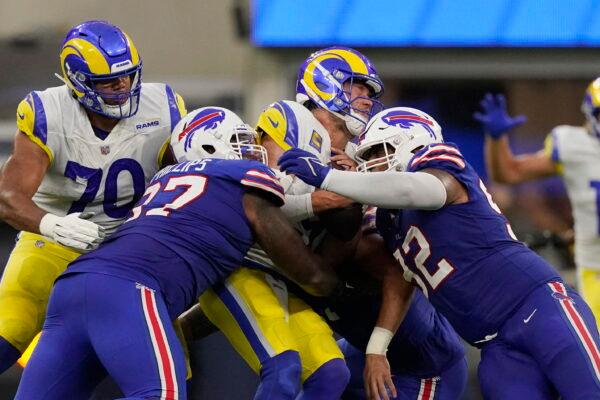 Los Angeles Rams quarterback Matthew Stafford, center, is tackled by Buffalo Bills defensive tackle Jordan Phillips, left, and defensive tackle DaQuan Jones during the first half of an NFL football game in Inglewood, Calif., Sept. 8, 2022. (Mark J. Terrill/AP Photo)