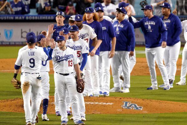 Members of the Los Angeles Dodgers congratulate each other after they defeated the Arizona Diamondbacks 5–2 in a baseball game in Los Angeles on Sept. 19, 2022. (Mark J. Terrill/AP Photo)