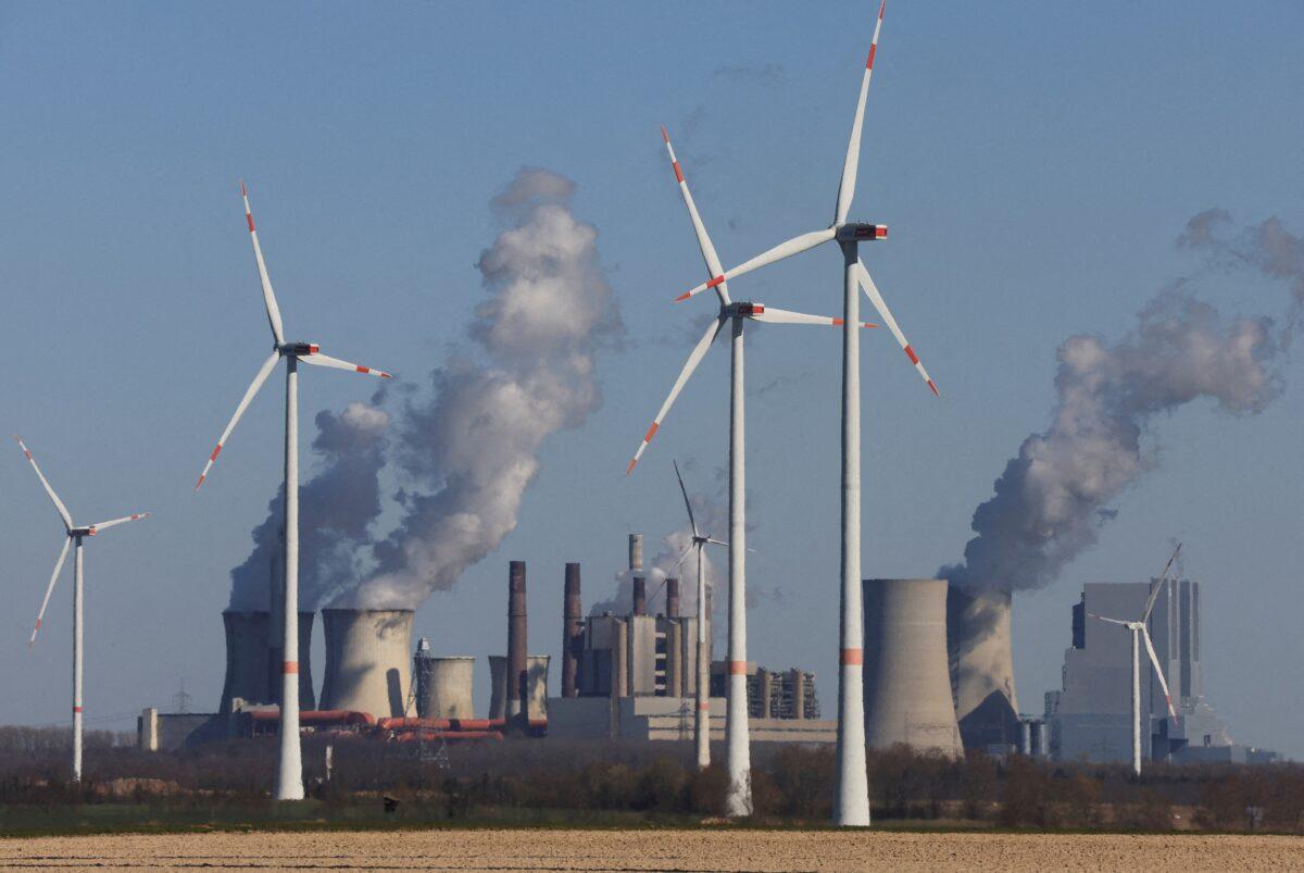 Wind power stations of German utility RWE, one of Europe's biggest electricity companies, in front of RWE's brown coal fired power plants of Neurath near Jackerath, north-west of Cologne, Germany, on March 18, 2022. (Wolfgang Rattay/Reuters)