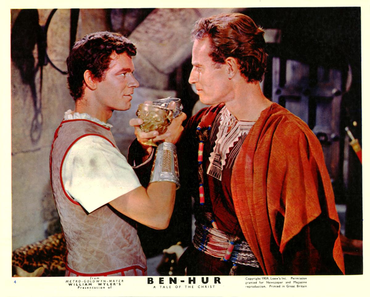 (L–R) Stephen Boyd as Massala meets with his boyhood friend Charlton Heston as Judah Ben Hur in a tense conversation while confirming their friendship. (MovieStillsDB)