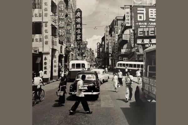 A symbolic Black and white snapshot was taken in a neighbourhood of Hong Kong in 1954 with neon light signs hanging high. By Raymond Cauchetier. (Courtesy of Boogie Woogie Photography)