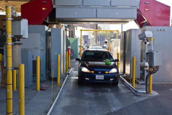 A car passes through an inspection booth and hi-tech scanners at the San Ysidro, Calif., port of entry, in this file photo. (Josh Denmark/CBP)