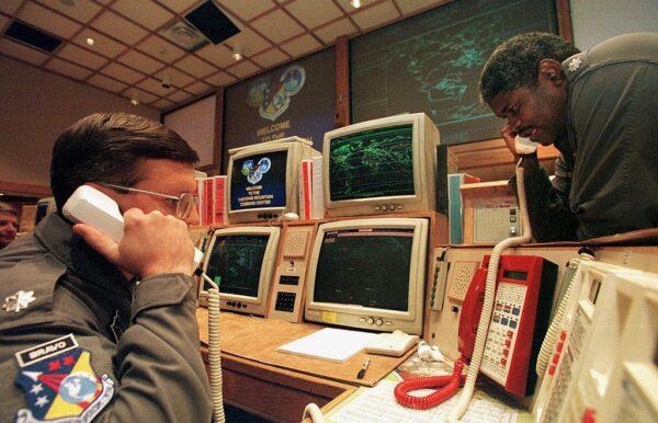  Missile Commanders Lt. (L) and Lt. Col. Ken Reed confirm a launch warning over the phone during a practice drill at the North America Aerospace Defense Command (NORAD) Cheyenne Mountain Complex in Colorado Springs, Colo., on Nov. 9, 1999. (Mark Leffingwell/AFP via Getty Images)