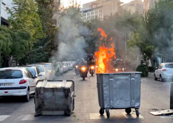 A bin burning in the middle of an intersection during a protest for Mahsa Amini, a woman who died after being arrested by the Islamic republic's "morality police," in Tehran on Sept. 20, 2022. (AFP via Getty Images)