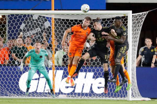 Houston Dynamo goalkeeper Steve Clark, left, looks on as defender Ethan Bartlow (13) headers away a shot on goal over Los Angeles FC midfielders Gareth Bale (11) and defender Jesus Murillo (3) during the second half of an MLS soccer match in Houston, Aug. 31, 2022. (Michael Wyke/AP Photo)