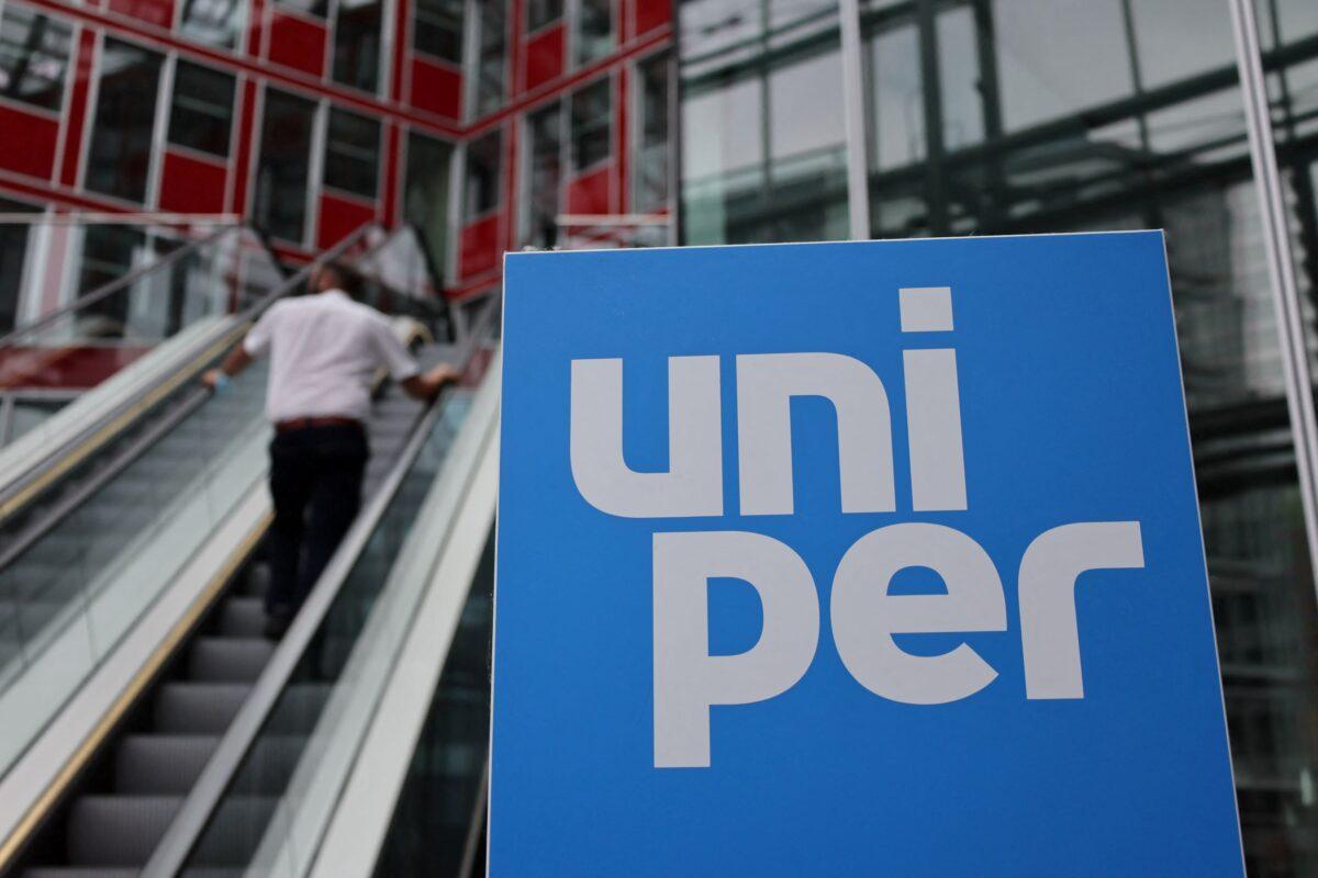 A person stands at escalators near the Uniper logo at the utility's firm headquarters in Duesseldorf, Germany, on July 8, 2022. (Wolfgang Rattay/Reuters)