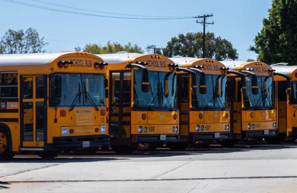 School buses sit parked near Newport Mesa Unified School District in Costa Mesa, Calif., on Sept. 21, 2022. (John Fredricks/The Epoch Times)