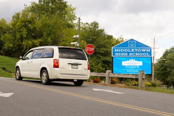 A car passes a Middletown High School sign on the ramp leading up to school campus on September 20, 2022. (Cara Ding/The Epoch Times)