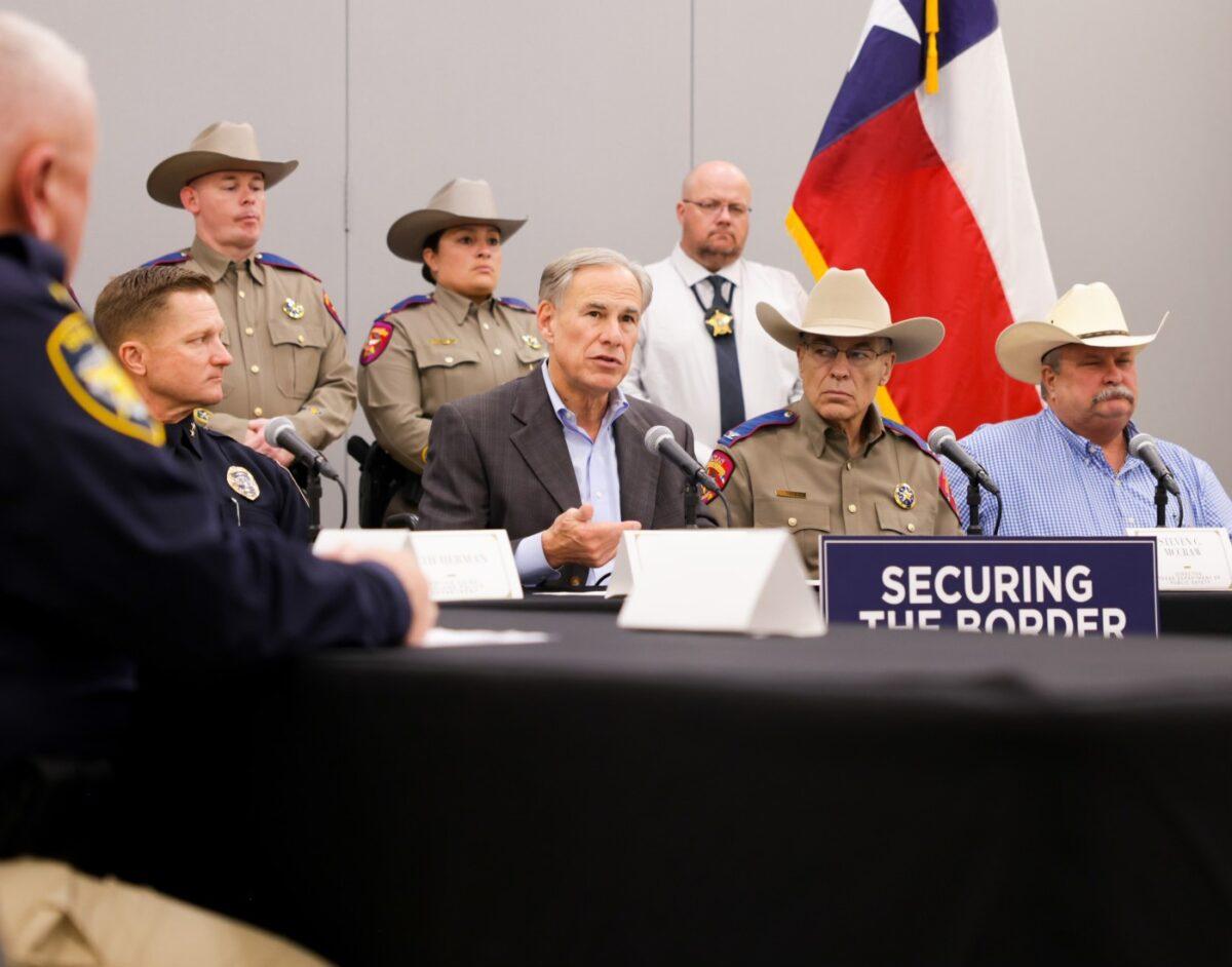 Texas Gov. Greg Abbott (C) is flanked by law enforcement personnel as he issues an executive order to designate Mexican cartels as terrorist organizations, in Midland, Texas, on Sept. 21, 2022. (Texas Governor's Office)
