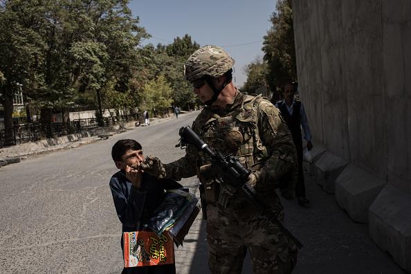An American soldier greets a local Afghan in Kabul, Afghanistan. During the withdrawal in 2021, soldiers had compassion for the frightened Afghan people, but they had to keep them off the runaway, so reinforcements and supplies could come in and transports planes could leave. (Andrew Renneisen/Getty Images)
