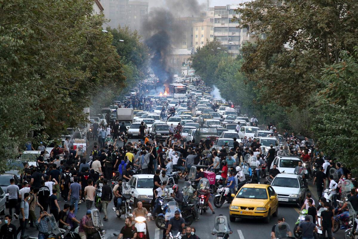 Protesters chant slogans during a protest over the death of a woman who was detained by the morality police, in downtown Tehran, Iran, on Sept. 21, 2022. (Obtained by AP)