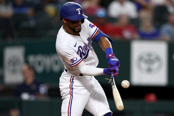 Leody Taveras (3) of the Texas Rangers hits a broken bat single against the Los Angeles Angels in the bottom of the second inning at Globe Life Field in Arlington, Texas, on Sept. 21, 2022. (Tom Pennington/Getty Images)