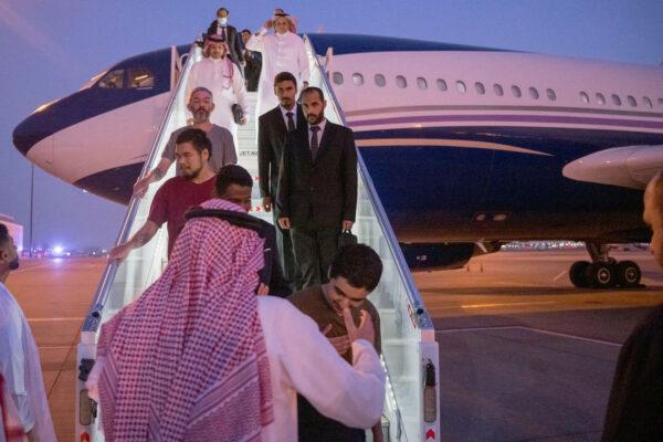 Ten prisoners of war (five British citizens, one Moroccan, one Swedish, one Croatian, and two Americans) are seen arriving in King Khalid International Airport, in Riyadh, Saudi Arabia, on Sept. 21, 2022. (Saudi Press Agency/Handout via Reuters)
