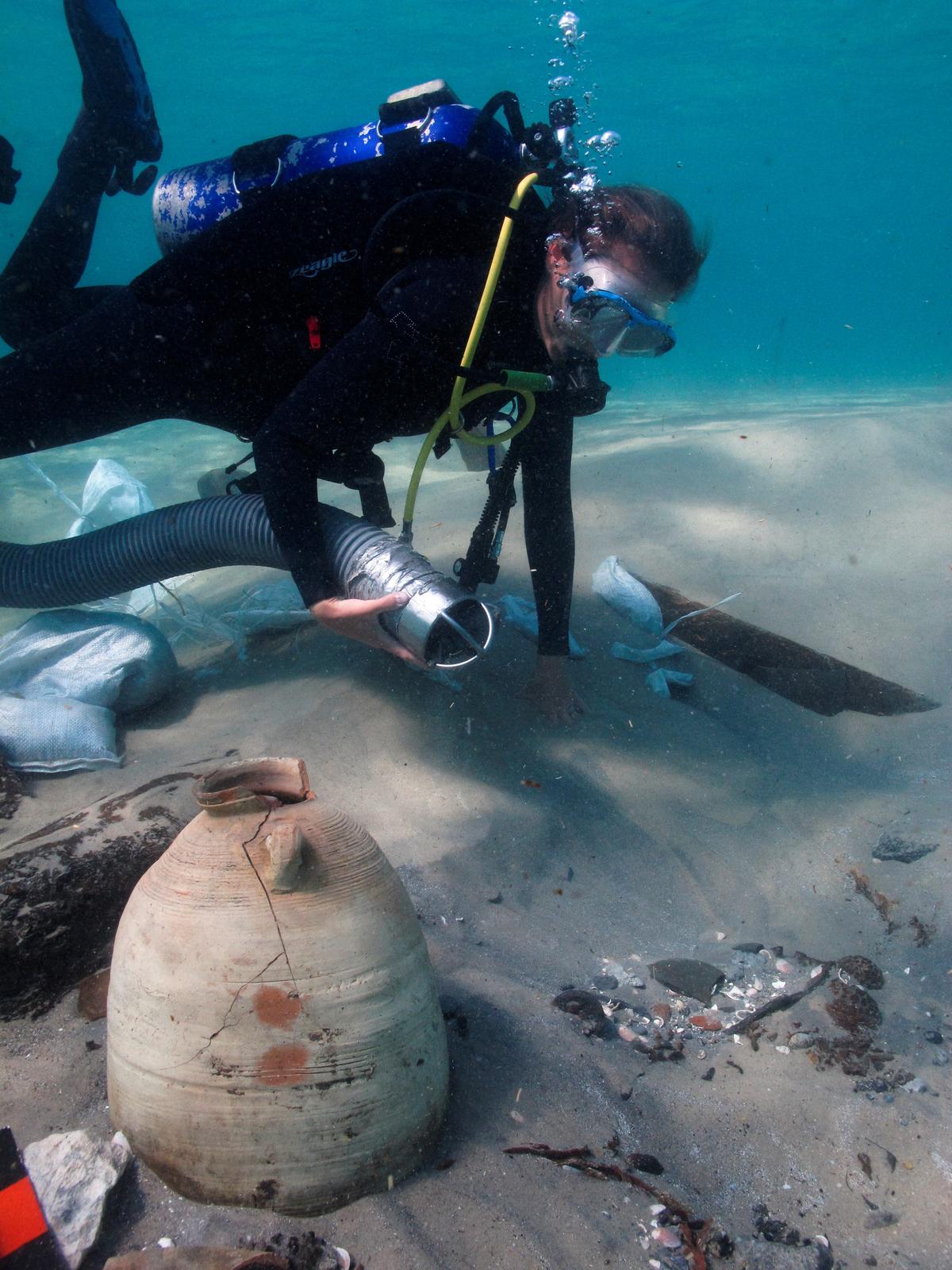 A diver excavates the remains of the wreck's antiquated cargo. (Reuters/Amir Yurman)