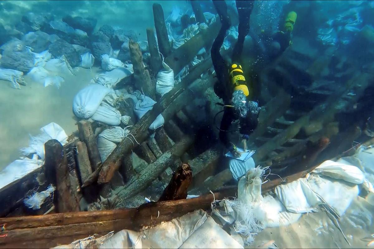 An underwater view of the excavation shows divers surveying the wreck on Oct. 24, 2021. (Reuters/Alexandros Sotiriou)