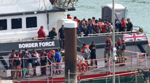 A group of illegal immigrants are brought into Dover, Kent, from a Border Force vessel following a small boat incident in the English Channel, on Sept. 22, 2022. (Gareth Fuller/PA Media)