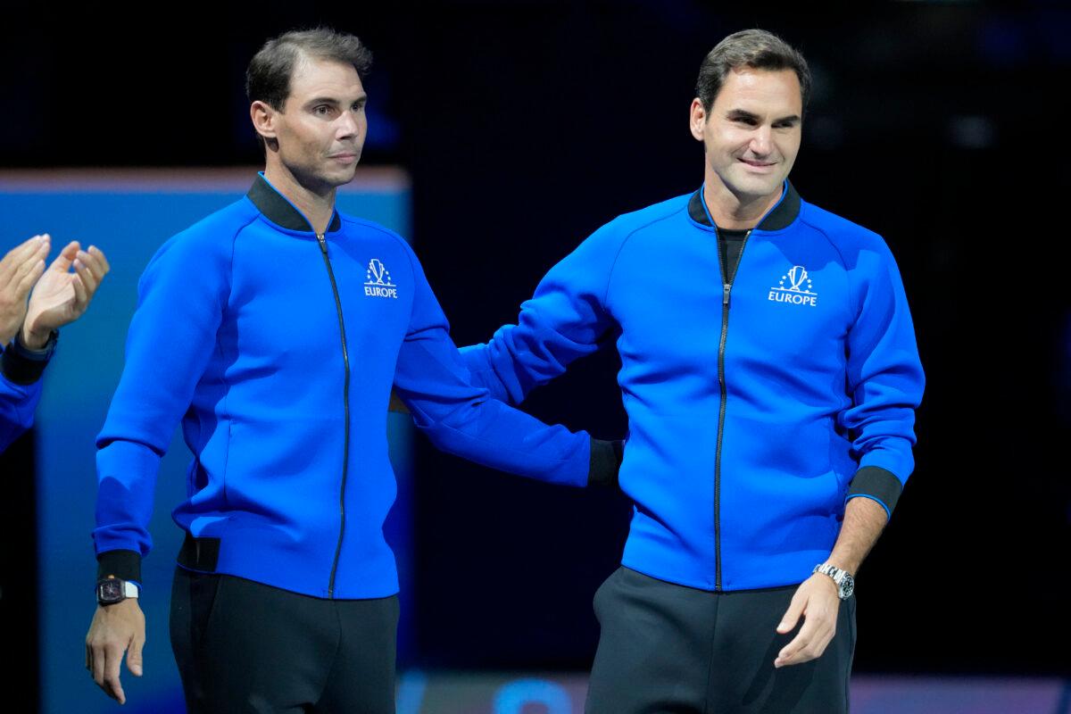 Team Europe's Roger Federer (R) of Switzerland and Rafael Nadal of Spain gesture before a match Team Europe's Andy Murray against Team World's Alex de Minaur on day one of the Laver Cup tennis tournament at the O2 in London on Sept. 23, 2022. (Kin Cheung/AP Photo)