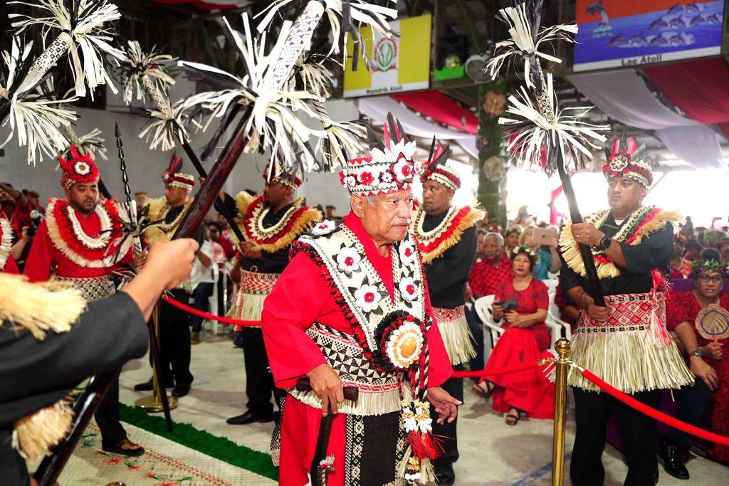 This picture taken on July 21, 2022, shows Marshall Islands Iroojlaplap (paramount chief) Michael Kabua walking through an honor guard of spear-holding warriors representing the 12 atolls and single islands in his domain at the start of a gala coronation ceremony on Ebeye Island in the Marshall Islands. Thousands of Marshall Islanders converged on Ebeye Island this week for the first coronation ceremony of a paramount chief in half a century. (Chewy Lin/AFP via Getty Images)