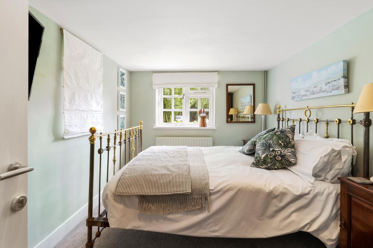 This ground-floor bedroom in the annex house oozes rustic charm; this timber-frame structure has three bedrooms and a kitchenette. (Courtesy of Mullucks - Part of Hunters)