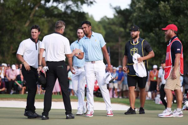 (L-R) Mito Pereira of Chile and Taylor Pendrith of Canada and the International Team shake hands with Max Homa and Tony Finau of the U.S. Team after Homa and Finau won the Thursday foursome matchup of the 2022 Presidents Cup at Quail Hollow Country Club in Charlotte, N.C., on Sept. 22, 2022. (Warren Little/Getty Images)